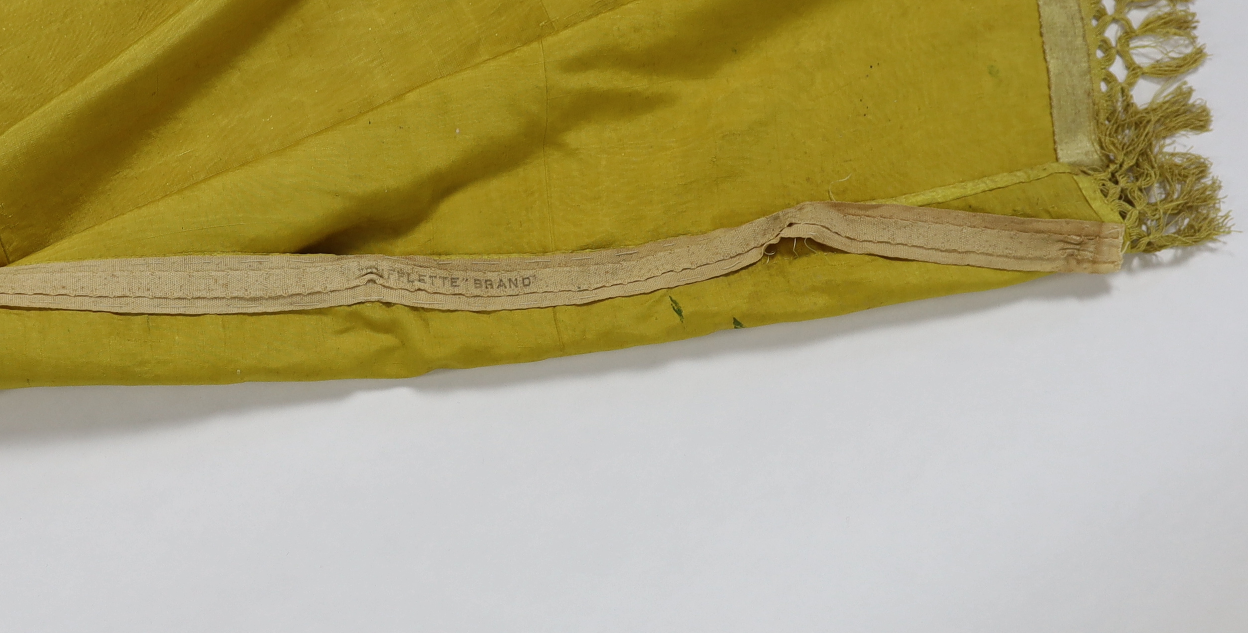 A large Regency yellow silk curtain, with fringed base, French short loom ribbed silk panels made into a wide curtain, with fringing on each side and at the bottom, 9ft wide x 8ft 6in. long